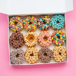 Fancy Dozen donuts topped with colorful cereal loops and chocolate in Dallas.