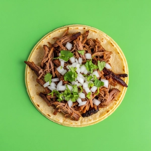 Barbacoa Taco with shredded beef, onion, and cilantro on a tortilla, Mexican cuisine in Dallas.