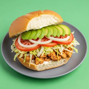 Chicken Torta with sliced avocado and tomato, featuring lettuce and grilled chicken in Dallas.