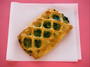 Spinach Feta Croissant with visible spinach and golden pastry in Dallas.