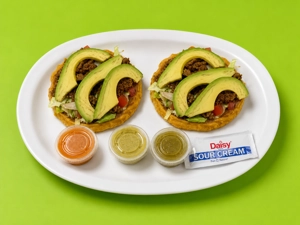 Sopes with beef, avocado, and lettuce served on a plate in Dallas.