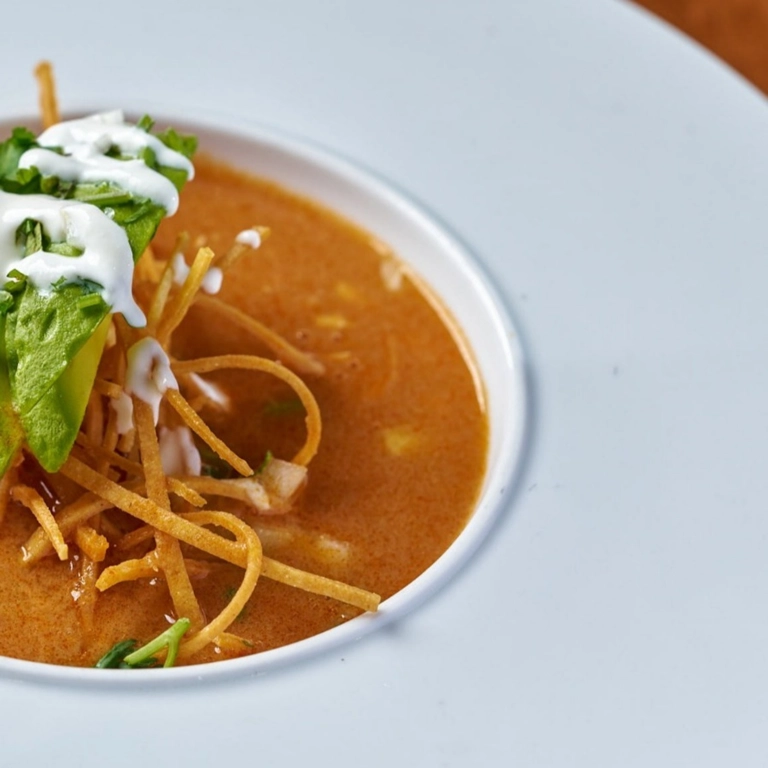 Sopa Azteca with avocado, tortilla strips, and cream in Wantagh.