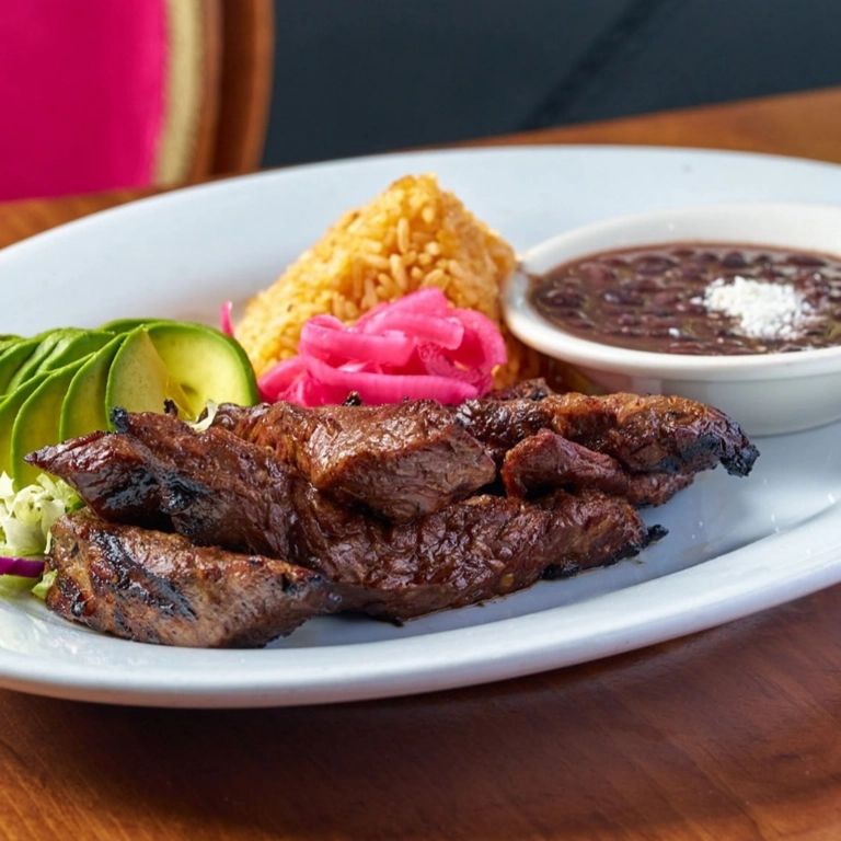 Mexican Faldita with grilled beef, avocado slices, rice, and beans in Wantagh.