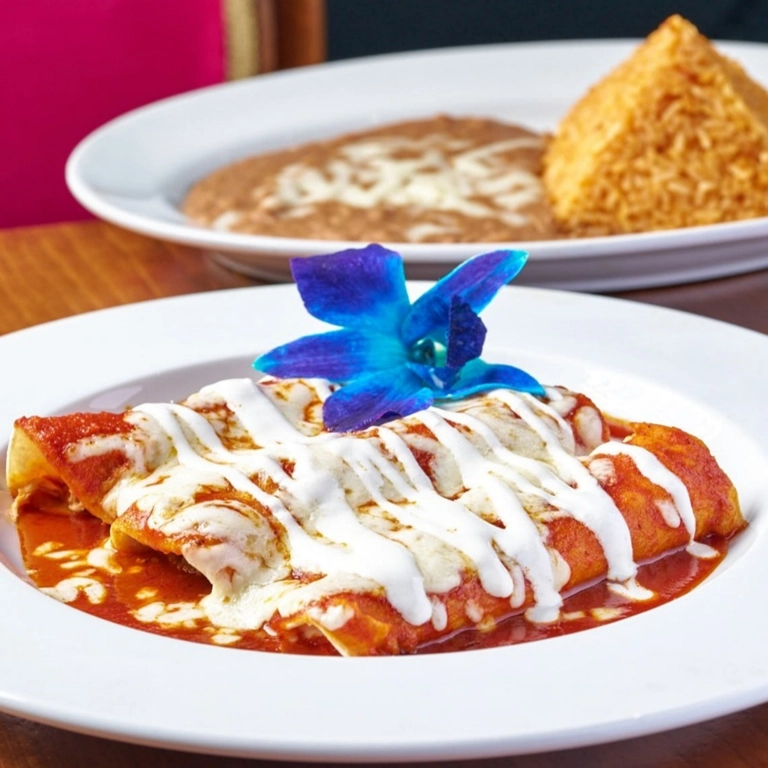 Enchiladas Rojas with red sauce and melted cheese, garnished with a blue flower, served in Wantagh.