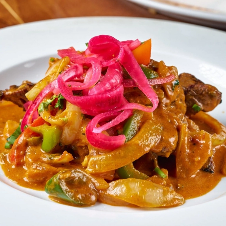 Carne Ranchera with grilled beef, red onions, and bell peppers in Wantagh.