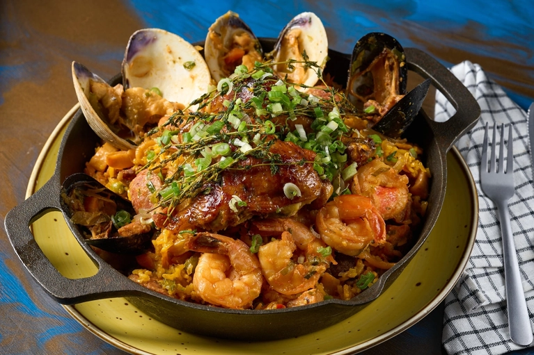 Paella Sabor a Colombia con camarones y almejas en una sartén. Cocina colombiana.