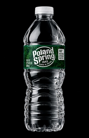 16.9oz bottle of Poland Spring water with a green label in Jackson Heights.