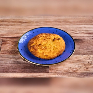 Arepa de Choclo Plain on a blue plate, showing a golden corn cake. Colombian cuisine, city unknown.