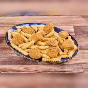 Chicken nuggets and crinkle-cut fries on a blue plate. Cuisine type and city unknown.