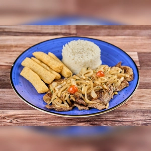Bistec Encebollado with onions, steak, yuca fries, and rice on a blue plate. Cuisine type unknown.