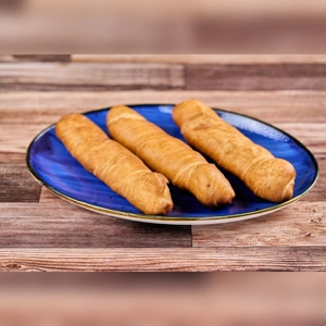Cheese Fingers on a blue plate, showing golden-brown pastry with cheese filling. Cuisine type and city unknown.