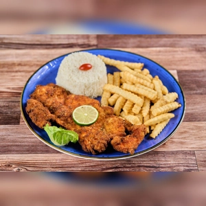 Milanesa de Pollo with a slice of lime, crinkle-cut fries, and a serving of rice on a blue plate. Cuisine type and city