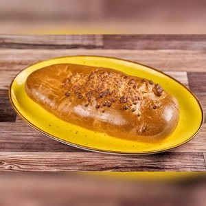Big Cheese Bread with a golden crust and visible cheese topping on a yellow plate. Unknown cuisine and city.