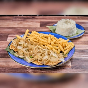 Pechuga Encebollada with grilled chicken breast topped with sautéed onions, served with crinkle-cut fries and a side of