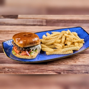 Hamburgesa Con Queso with lettuce, tomato, and crinkle-cut fries on a blue plate. Cuisine type unknown.