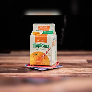 Tropicana Juice carton with orange and straw. Unknown cuisine and city.