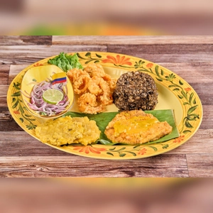 Manjar del Mar with fried calamari, rice, and plantains on a decorative plate. Colombian cuisine in an unknown city.