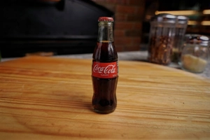 Coca-Cola bottle on a wooden table at Donabella in New York.