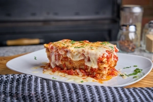 Homemade lasagna with melted cheese and tomato sauce, served in New York.