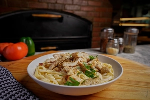 Fettuccine Alfredo with grilled chicken and parsley in New York.