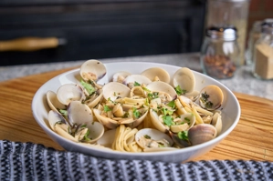 Linguine with clam sauce featuring visible clams and parsley in a bowl. New York.