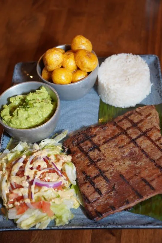 Sobrebarriga a la Parrilla colombiana con carne asada, guacamole, arroz y ensalada en Norcross.