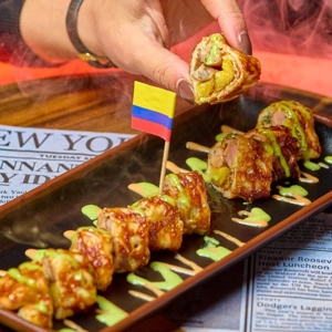 SuChicharron with smoked chicharron and maduro, drizzled with house sauces, served in Jackson Heights.