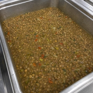 Lentejas with visible lentils, red peppers, and onions at a Latin restaurant in Carrollton, TX.
