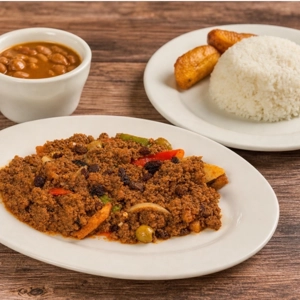 Cuban-Style Minced Beef with visible peppers, olives, and raisins, served in Union City. Accompanied by a side of rice and