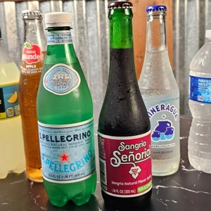 Variety of bottled drinks including sparkling water and soda at Super Tacos in Dacula.