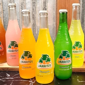 Jarritos soda bottles in various flavors including guava, mandarin, and pineapple at Super Tacos in Dacula.
