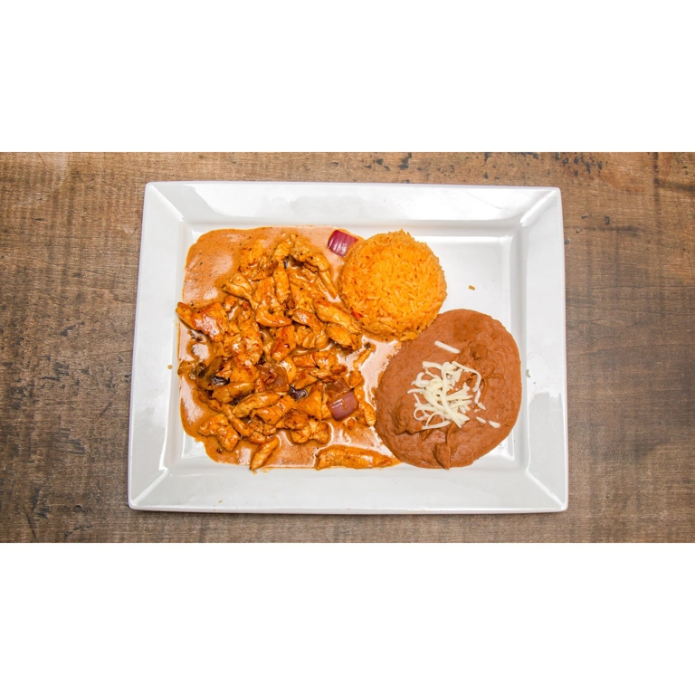 Pollo con Crema with chicken, onions, rice, and beans served in Roanoke.