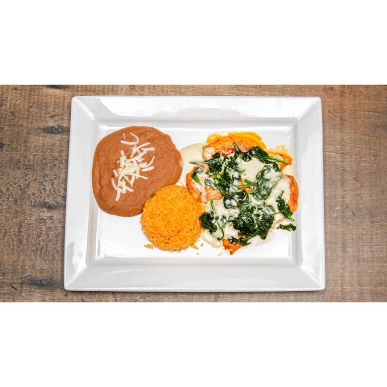 Pollo Popeye with grilled chicken, spinach, and cheese dip, served with rice and beans in Roanoke.