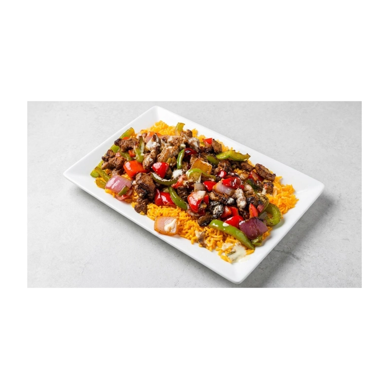 Chicken fajitas with grilled peppers and onions on a bed of rice, served in a Mexican restaurant in Roanoke.