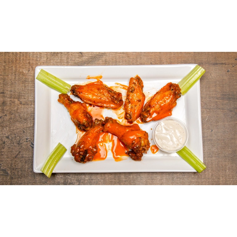 Chicken wings with buffalo sauce, celery sticks, and a side of ranch dressing in Roanoke.
