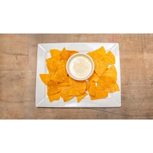 Cheese dip with crispy tortilla chips on a white plate, served in Roanoke.