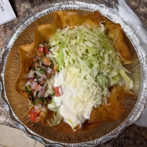 Taco Salad in a crispy tortilla bowl with visible lettuce, cheese, and pico de gallo in Roanoke.