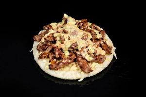 Arepa Skirt Steak with grilled steak and melted cheese on a corn arepa. Cuisine type and city unknown.
