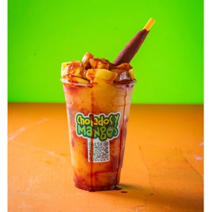 Mangonada with diced mango, chamoy, and a tamarind stick in Jackson Heights.