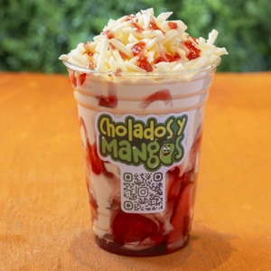 Fresas con Crema Queso with strawberries and cream topped with shredded cheese in Jackson Heights.
