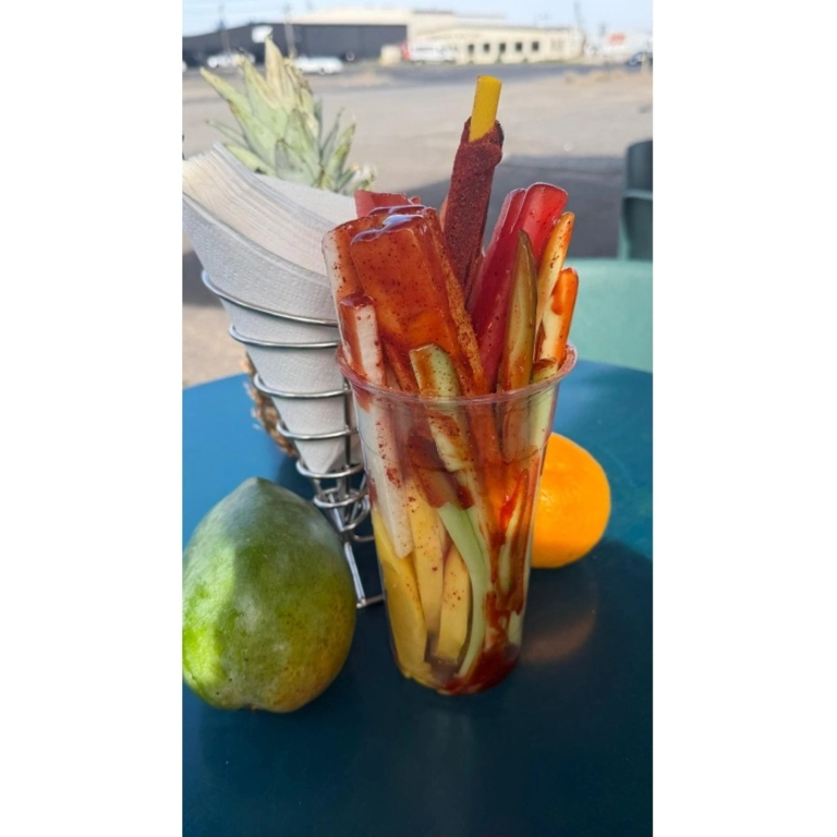 Fruta 24oz with mango and cucumber sticks topped with chili powder in Hermiston.