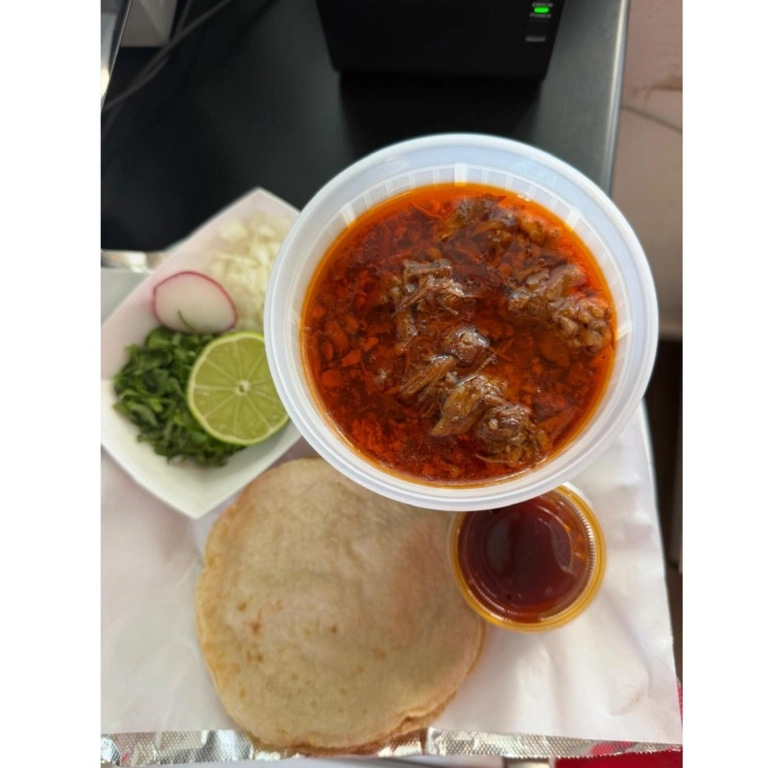 Plato De birria with shredded meat in broth, served with tortillas, lime, and radish in Hermiston.