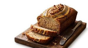 Banana loaf cake with sliced bananas and walnuts on top in Union City.