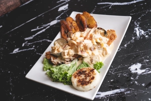 Breaded Fish Fillet Topped with Seafood